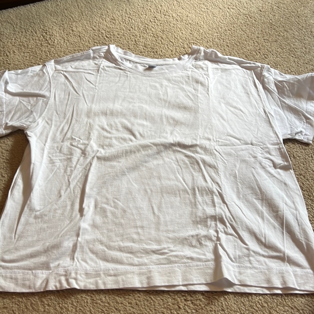 White T-shirt, boxy style.